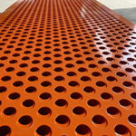 Orange, round, perforated plate with an 8-3 hole pattern